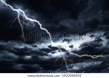 Lightning strike against the background of a cloudy dark sky.