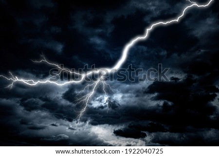 Lightning strike against the background of a cloudy dark sky. Royalty-Free Stock Photo #1922040725