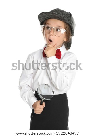 Cute little child in hat with magnifying glass playing detective on white background