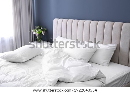 White soft pillows on comfortable bed indoors Royalty-Free Stock Photo #1922043554