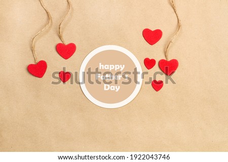 Happy father day greeting with red hearts on a brown paper background