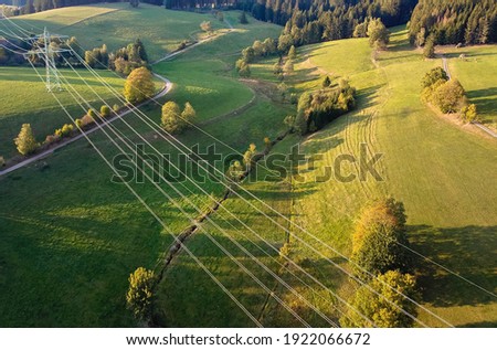 Drone photography of the power line over a green meadow. Green energy. Royalty-Free Stock Photo #1922066672