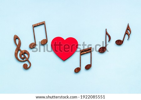 Love songs - musical wooden notes with heart, top view Royalty-Free Stock Photo #1922085551