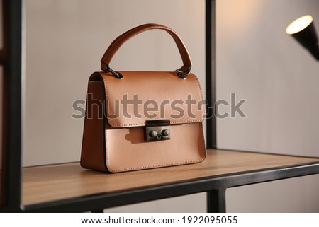 Elegant brown bag on shelf in luxury boutique Royalty-Free Stock Photo #1922095055