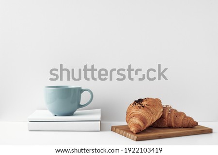Mug and croissants on a white background. Eco-friendly and natural materials in the decor, dessert. Copy space, mock up.