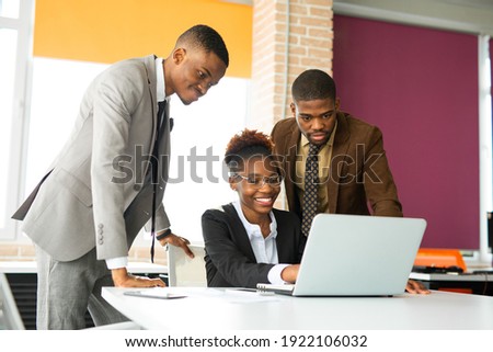 team of young african people in office at table with laptop  Royalty-Free Stock Photo #1922106032