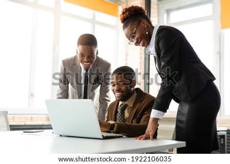 team of young african people in office at table with laptop 