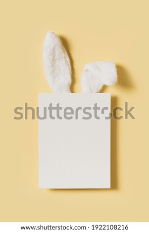 Easter mock up with rabbit poster on pink background, copy space, flat lay, top view