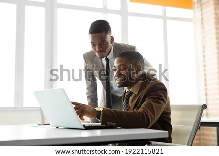 team of young african men in office at table with laptop  Royalty-Free Stock Photo #1922115821