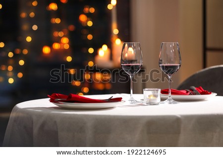 Table setting for romantic dinner in restaurant Royalty-Free Stock Photo #1922124695