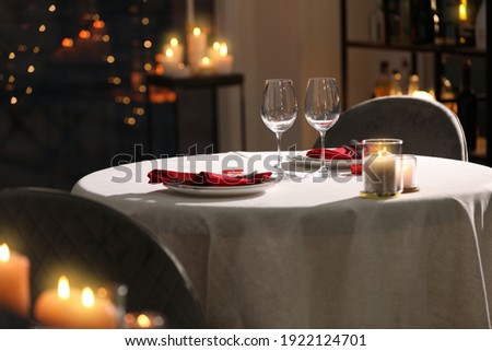 Table setting for romantic dinner in restaurant Royalty-Free Stock Photo #1922124701