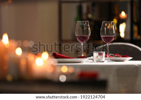 Table setting for romantic dinner in restaurant Royalty-Free Stock Photo #1922124704