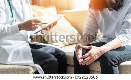 Menopause woman, stressful patient consulting with doctor or psychiatrist who diagnostic examining on obstetric - gynaecological female illness, or mental health in medical clinic or hospital  Royalty-Free Stock Photo #1922128586