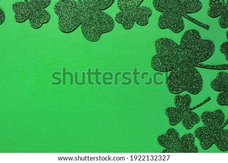 Flat lay composition with clover leaves on light green background, space for text. St. Patrick's Day celebration