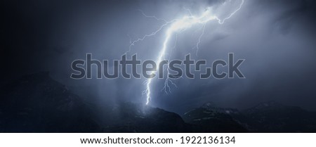 Lightning over mountains and lake. Switzerland.
