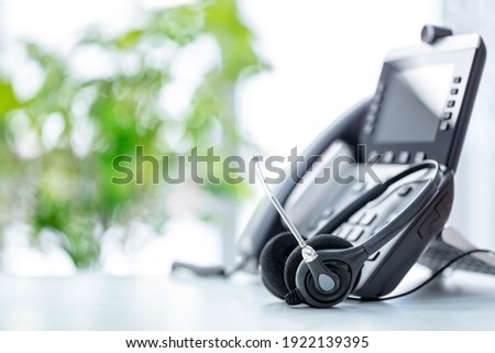 VOIP headset headphones telephone with microphone on office desk concept for communication, it support, call center and customer service help desk Royalty-Free Stock Photo #1922139395