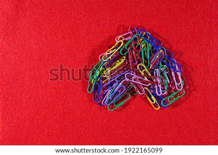 Romantic picture. Stationery romance. Heart of colored paper clips