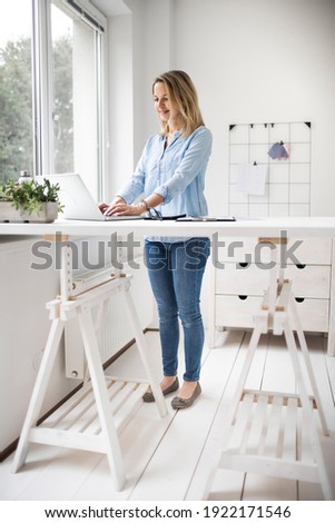 Businesswoman working at a standing desk in office