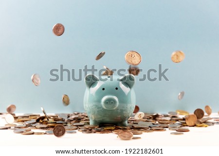 Piggy Bank With Falling Coins From Above - Business and Finance Concept