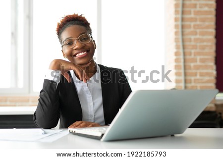 beautiful young african woman in glasses with laptop  Royalty-Free Stock Photo #1922185793