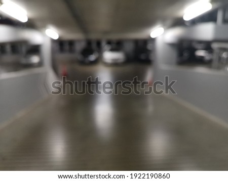 Blur focus of parking lot underground interior.