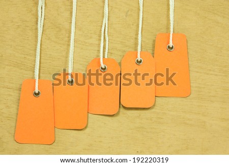 blank price tag hang on wooden background