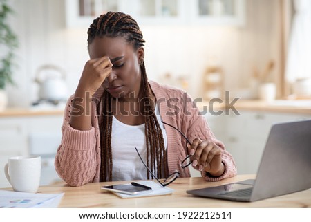 Eyes Strain. Overworked Black Freelancer Woman Tired After Using Laptop In Kitchen While Working Remotely On Computer At Home Office, Upset African American Lady Rubbing Nose Bridge, Free Space Royalty-Free Stock Photo #1922212514