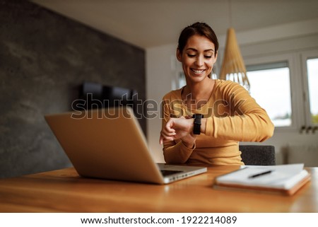 Portrait of business woman, looking at her wrist watch. Royalty-Free Stock Photo #1922214089