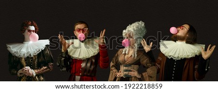 Blowing pink bubble gums. Medieval people as a royalty persons in vintage clothing on dark background. Concept of comparison of eras, modernity and renaissance, baroque style. Creative collage. Flyer Royalty-Free Stock Photo #1922218859