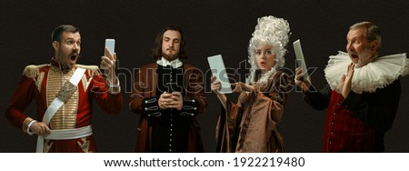 Scrolling phones, online sales. Medieval people as a royalty persons in vintage clothing on dark background. Concept of comparison of eras, modernity and renaissance, baroque style. Creative collage. Royalty-Free Stock Photo #1922219480