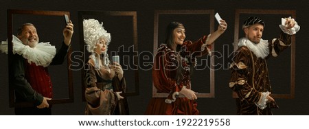 Selfie framing, devices. Medieval people as a royalty persons in vintage clothing on dark background. Concept of comparison of eras, modernity and renaissance, baroque style. Creative collage. Flyer Royalty-Free Stock Photo #1922219558