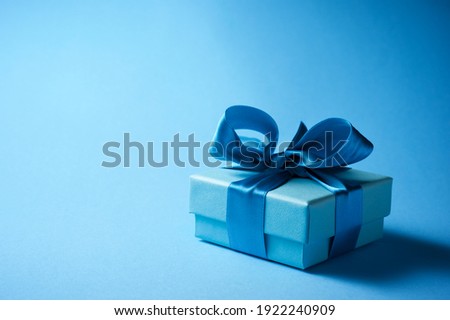 Luxury box tied with a blue ribbon. Royalty-Free Stock Photo #1922240909