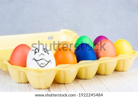 Easter holiday concept. Easter picture, multi-colored eggs in a plastic form, on a white background