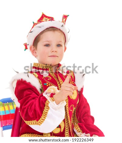Little cute serious boy dressed as a king, isolated on white background