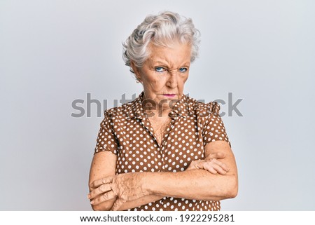 Senior grey-haired woman wearing casual clothes skeptic and nervous, disapproving expression on face with crossed arms. negative person.  Royalty-Free Stock Photo #1922295281