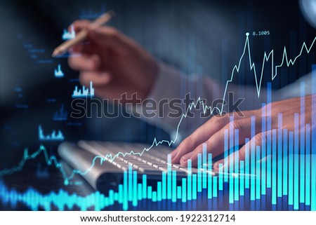 Hands typing the keyboard to research stock market to proceed right investment solutions. Internet trading and wealth management concept. Formal wear. Hologram Forex chart over close up shot. Royalty-Free Stock Photo #1922312714