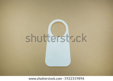 WHITE DOOR TAG ON beige background