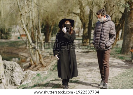 People in the city. Persons in a masks. Coronavirus theme. Couple walks during quarantine.