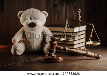 Divorce and alimony concept. Wooden gavel and teddy bear in notary public office Royalty-Free Stock Photo #1922353628