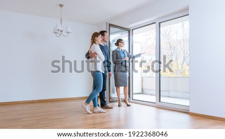 Young couple getting tour through apartment they consider renting or purchasing Royalty-Free Stock Photo #1922368046