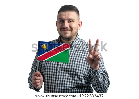 White guy holding a flag of Namibia and shows two fingers isolated on a white background.