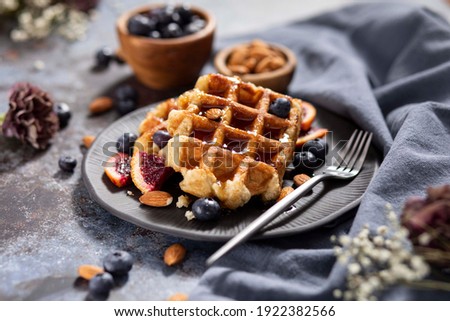 Homemade Belgium Waffles with Blueberries and Almonds Royalty-Free Stock Photo #1922382566