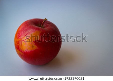 Red apple stand on a white surface
