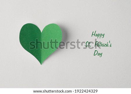 Closeup view photo of paper heart with shadow in green color isolated white color backdrop with text