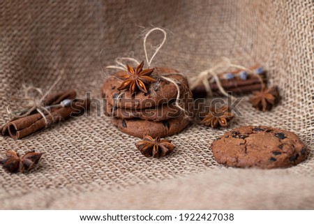 cookies with chocolate and spices on the background of sackcloth, cinnamon and badian. Bakery products