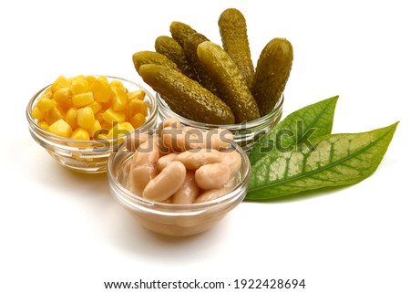Canned corn, pickles and beans, non-perishable food, isolated on white background. High resolution image.
