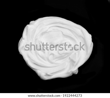 whipped cream or meringue isolated on black background.  Royalty-Free Stock Photo #1922444273