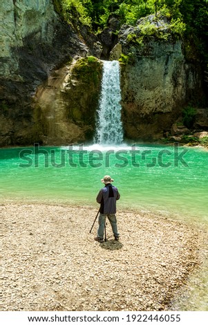 Photographer taking pictures at waterfall. sati ozdemir