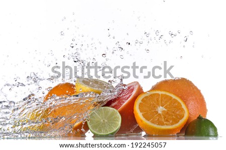 Fresh fruit with water splash over white background