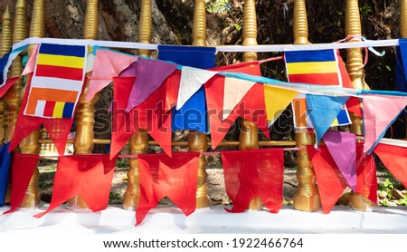 Waving colorful Buddhist Sri Lanlan Flag in cloudy blue sky background